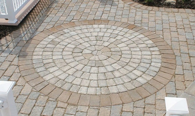 Custom paver patio with a circular inlay pattern