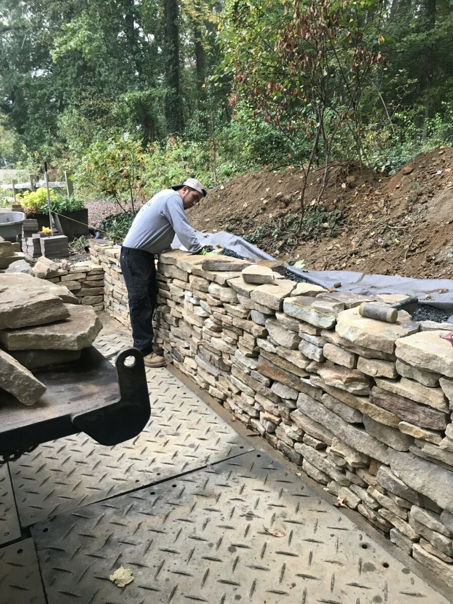 Green Acres crew building a natural stone retaining wall
