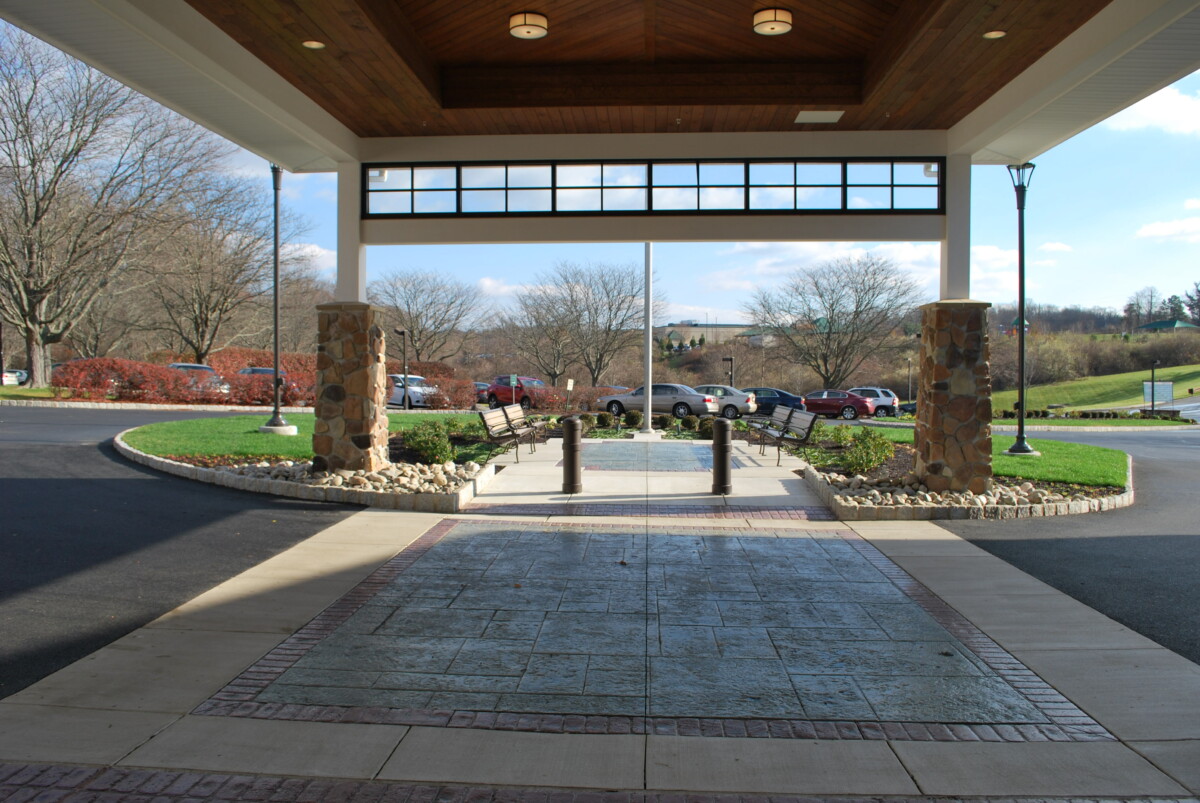 Green Acres crew planting shrubs along a commercial walkway