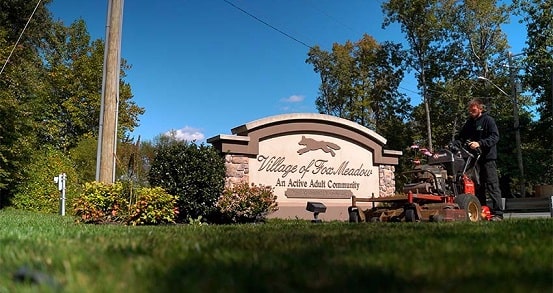 Mowing crew maintaining the entrance of a Delaware community