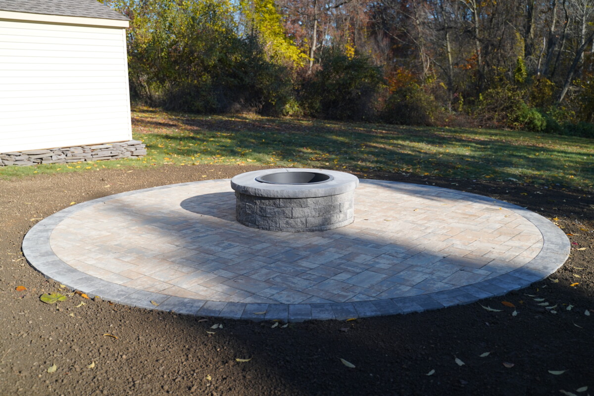Custom stone fire pit built by Green Acres in a Delaware backyard