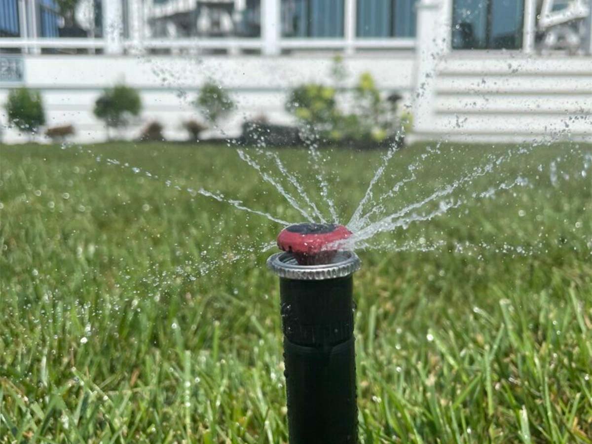 Irrigation system watering a residential lawn
