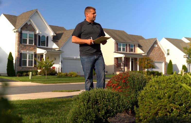 Green Acres professional reviewing a commercial property plan with a client