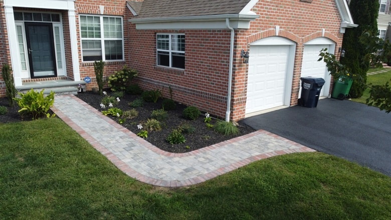 Paver walkway curving toward the front door of a Delaware home
